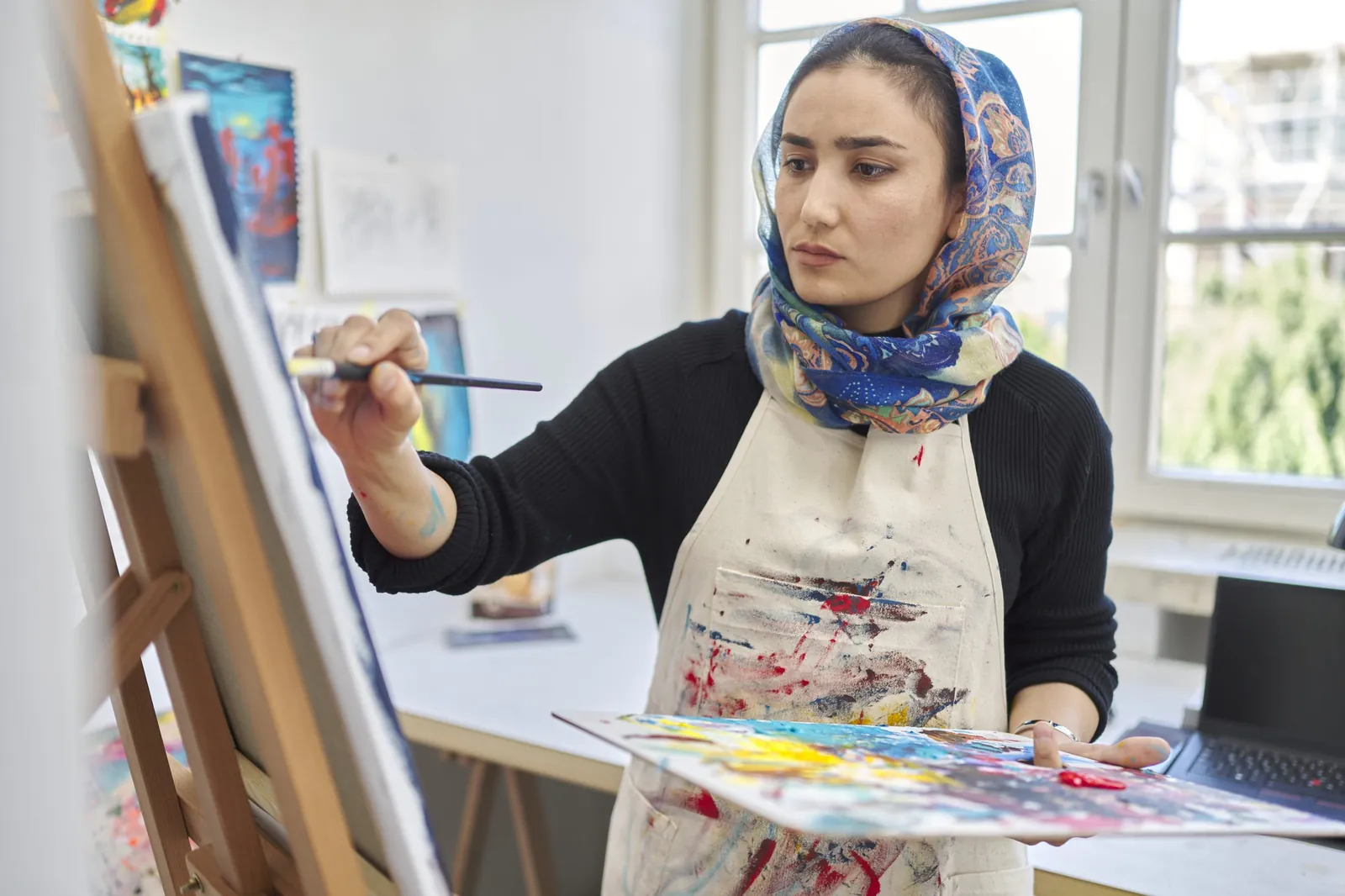 Nabila Horakhsh painting in her studio
