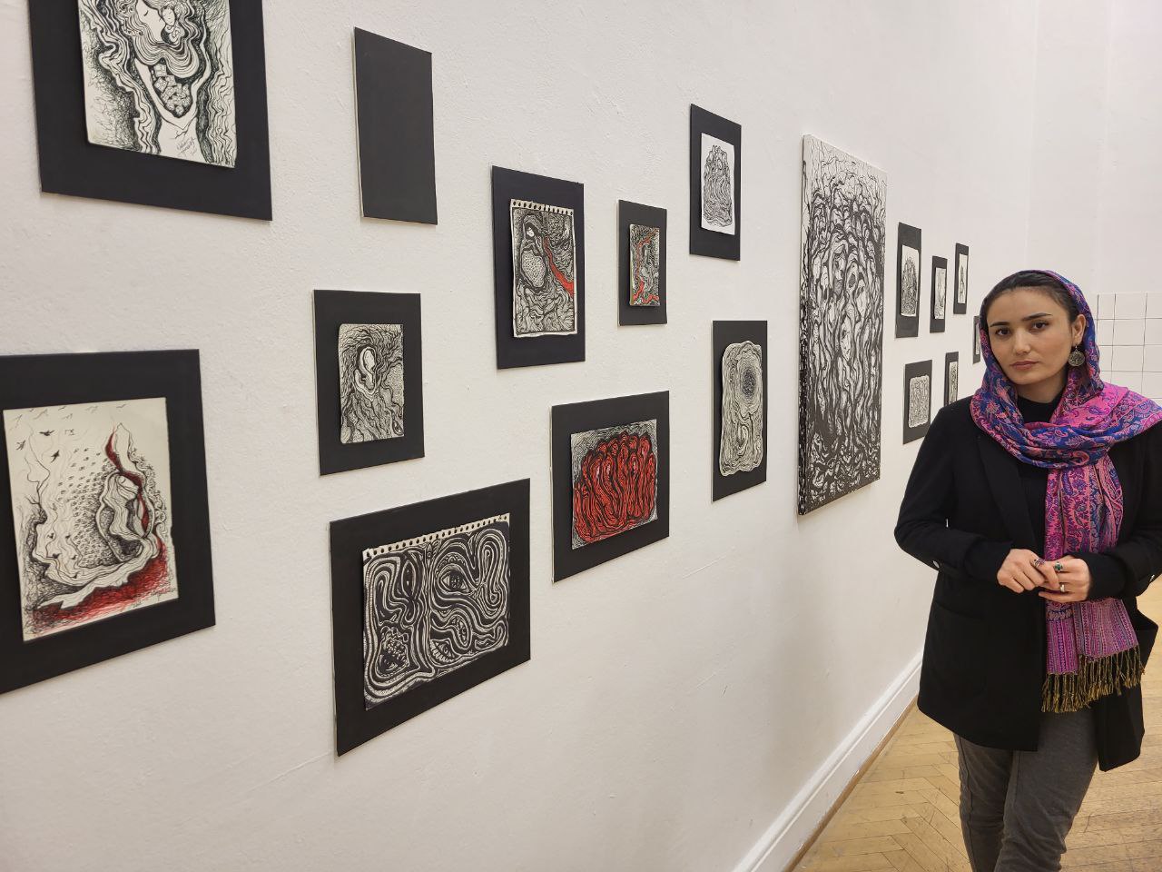 Nabila Horakhsh with drawings installed in an exhibition